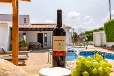 a bottle of wine sitting on a table next to a glass at Casa Salácia in Aljezur