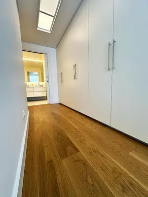 an empty room with white cabinets and a wooden floor at Acqua Mar in Funchal