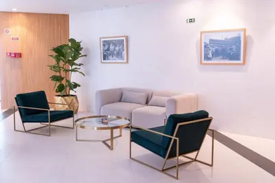 a living room with a couch and two chairs and a table at Acqua Mar in Funchal