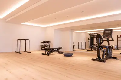 a gym with treadmills and exercise equipment in a room at Acqua Mar in Funchal