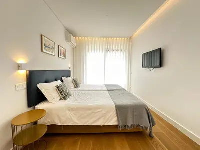 a bedroom with a large bed and a window at Acqua Mar in Funchal