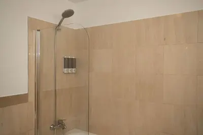 a shower with a glass door in a bathroom at Apartamento Janela do Atlantico in Machico