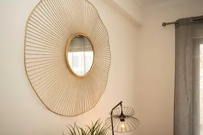 a mirror hanging on a wall in a bathroom at Apartamento Janela do Atlantico in Machico
