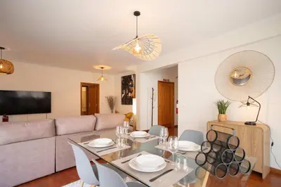 a living room with a table and a couch at Apartamento Janela do Atlantico in Machico