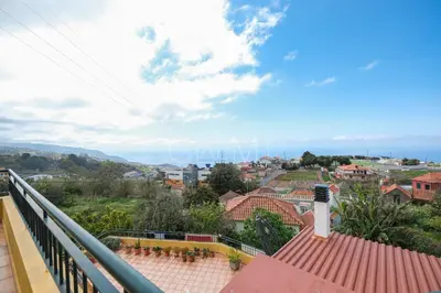a view of a town with the ocean in the background at Nati's House by GALMI in Ponta do Sol