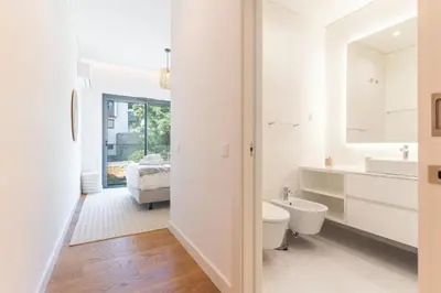 a white bathroom with a toilet and a sink at Babi by the Sea by Atlantic Holiday in Funchal