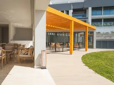 a patio with tables and chairs in a building at Babi by the Sea by Atlantic Holiday in Funchal