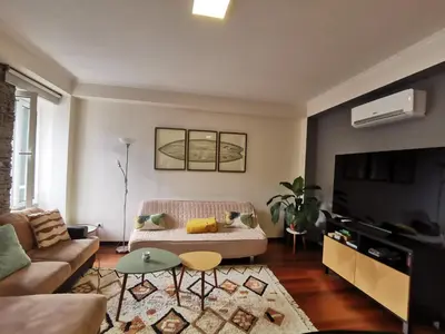a living room with a couch and a tv at Surf Nest in Machico
