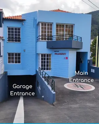 a blue building with a main entrance in front of it at Surf Nest in Machico