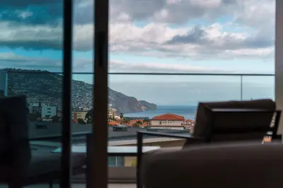 a view of the ocean from a room with a window at GuestReady - The perfect view in Funchal in Funchal