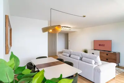 a living room with a white couch and a table at GuestReady - The perfect view in Funchal in Funchal