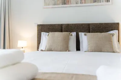 a bedroom with a white bed with pillows at GuestReady - The perfect view in Funchal in Funchal