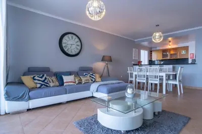 a bedroom with a bed with a view of the ocean at Apartment 7 on Paul do Mar Beach in Paul do Mar