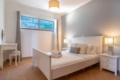 a kitchen with wooden cabinets and a sink at Apartment 7 on Paul do Mar Beach in Paul do Mar