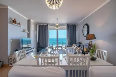 a living room with a couch and a table at Apartment 7 on Paul do Mar Beach in Paul do Mar