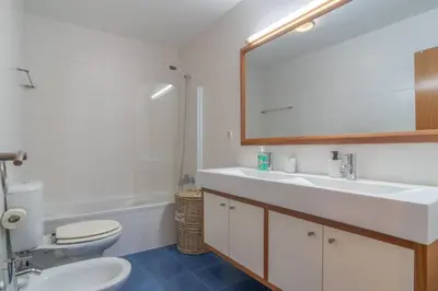 a bathroom with a sink and a toilet and a mirror at Apartment 7 on Paul do Mar Beach in Paul do Mar
