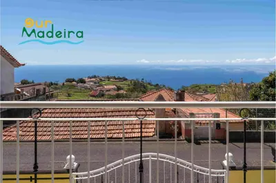 a view of the ocean from the balcony of a house at OurMadeira - Yellow House in Raposeira do Logarinho