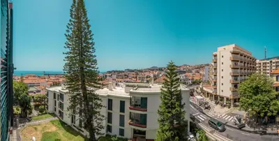 a bedroom with a bed with towels on it at Elias Garcia T3 Apartment in Funchal