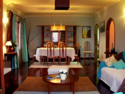 a living room with a table and a couch at Villa São Paulo in Funchal