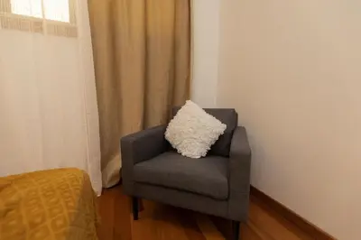 a pillow sitting on a chair in a room at Monumental Miramar Apartment by Rent-a-key in Funchal