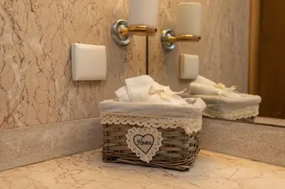 a bathroom with a basket of towels and a mirror at Monumental Miramar Apartment by Rent-a-key in Funchal