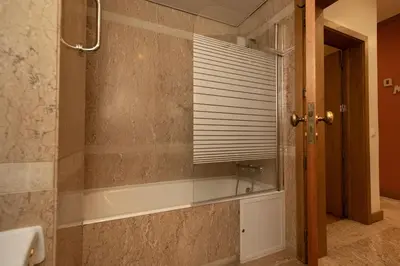 a bathroom with a bath tub and a window at Monumental Miramar Apartment by Rent-a-key in Funchal