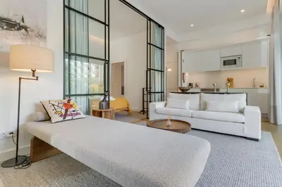 a living room with two white couches and a kitchen at Acqua - Private Swimming Pool in Funchal