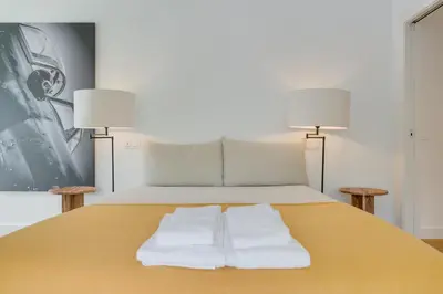 a bedroom with a bed with two white towels on it at Acqua - Private Swimming Pool in Funchal
