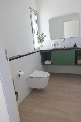a bathroom with a toilet and a sink and a mirror at Quinta do Munot in Raposeira do Logarinho