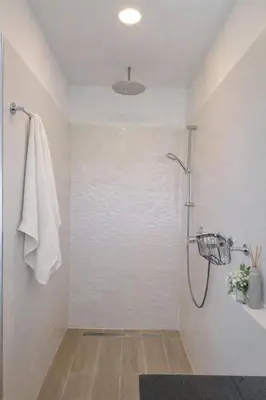 a bathroom with a shower with a glass door at Quinta do Munot in Raposeira do Logarinho