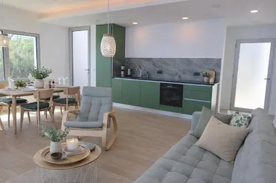 a living room with a couch and a table at Quinta do Munot in Raposeira do Logarinho