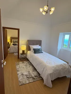 a bedroom with a large bed and a mirror at The Blue Cottage in Gaula