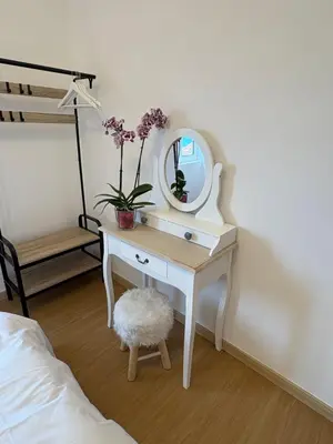 a bedroom with a white dressing table with a mirror at The Blue Cottage in Gaula