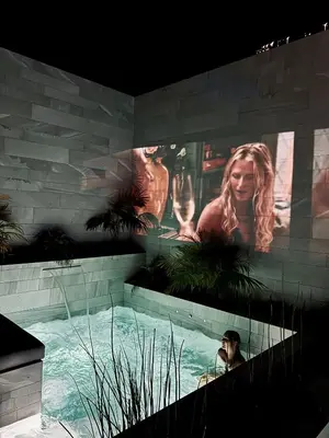 a man standing in a swimming pool in a building at Saudade Residence - Ultra Luxury Futuristic Ocean Zen Retreat in Ribeira Brava