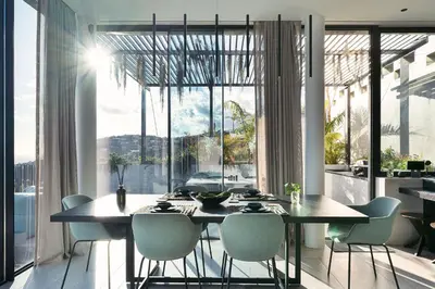 a dining room with a table and chairs and a large window at Saudade Residence - Ultra Luxury Futuristic Ocean Zen Retreat in Ribeira Brava