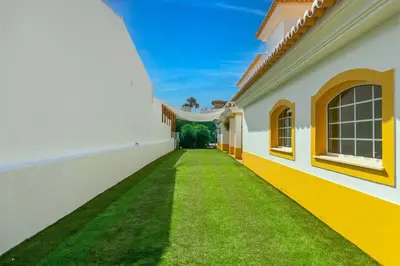 a hallway of a house with green grass at Vila Rolas - Beautiful 5 bed villa with pool and aircon 3 min to Luz beach in Luz