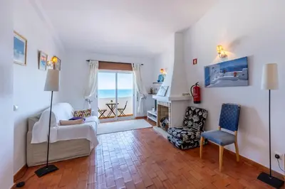 a balcony with a bench and a view of the ocean at incredible view- T1 Salema in Salema