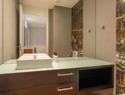 a bathroom with a sink and a large mirror at FLH Funchal Elegant Apartment with Pool & Balcony in Funchal