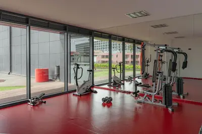 a gym with several treadmills and elliptical machines at FLH Funchal Elegant Apartment with Pool & Balcony in Funchal
