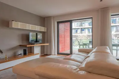 a living room with a couch and a large window at FLH Funchal Elegant Apartment with Pool & Balcony in Funchal