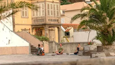 a living room with a flat screen tv on a wall at Pauloldtown - Local experience w rooftop n jacuzzi in Paul do Mar