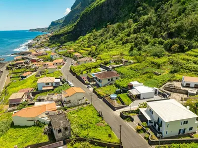 an aerial view of a village next to the ocean at Fajã Lodges - House Ash in São Vicente