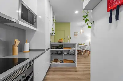 a kitchen with white cabinets and a counter top at Green Living-Funchal in Funchal