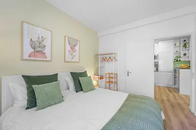 a bedroom with a large white bed with green pillows at Green Living-Funchal in Funchal