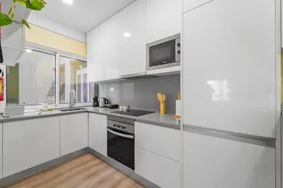 a kitchen with white cabinets and a microwave at Green Living-Funchal in Funchal