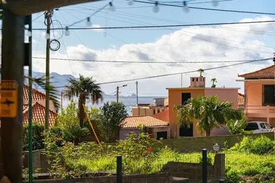 a view of a town with houses and palm trees at Fajã Lodges - Studio Ash in São Vicente