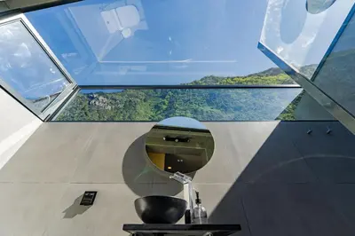 a mirror in a room with a glass ceiling at Fajã Lodges - Studio Ash in São Vicente