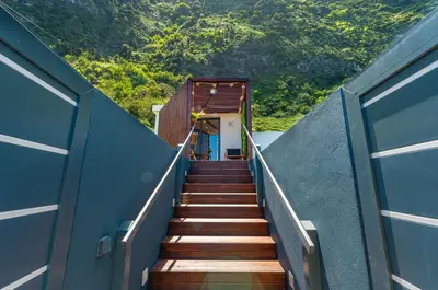 a stairway leading up to a building with a stair case at Fajã Lodges - Studio Ash in São Vicente