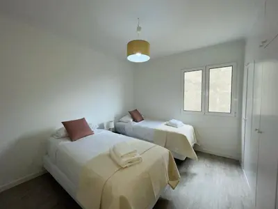 a white room with two beds and a window at Piornais Apartment by Susys Holidays in Funchal