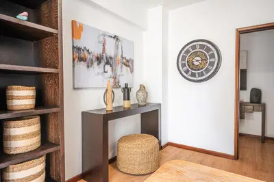 a living room with a table and a mirror at Portola Penthouse by YMR in Funchal